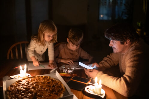 A dad and his children during a blackout
